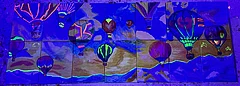 'The Sky is the Limit': A puzzle image showing hot air balloons on the sky. The picture is decided in 7 columns and two rows. The parts don't perfectly match. The Picture is illuminated under black light, and some highlights are fluorescent.
